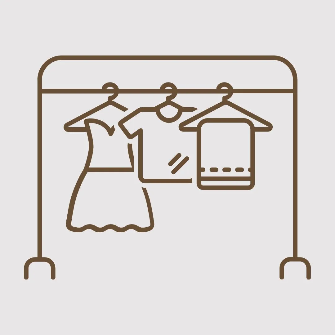 A clothes rail hung with a dress, a shirt and a folded jumper