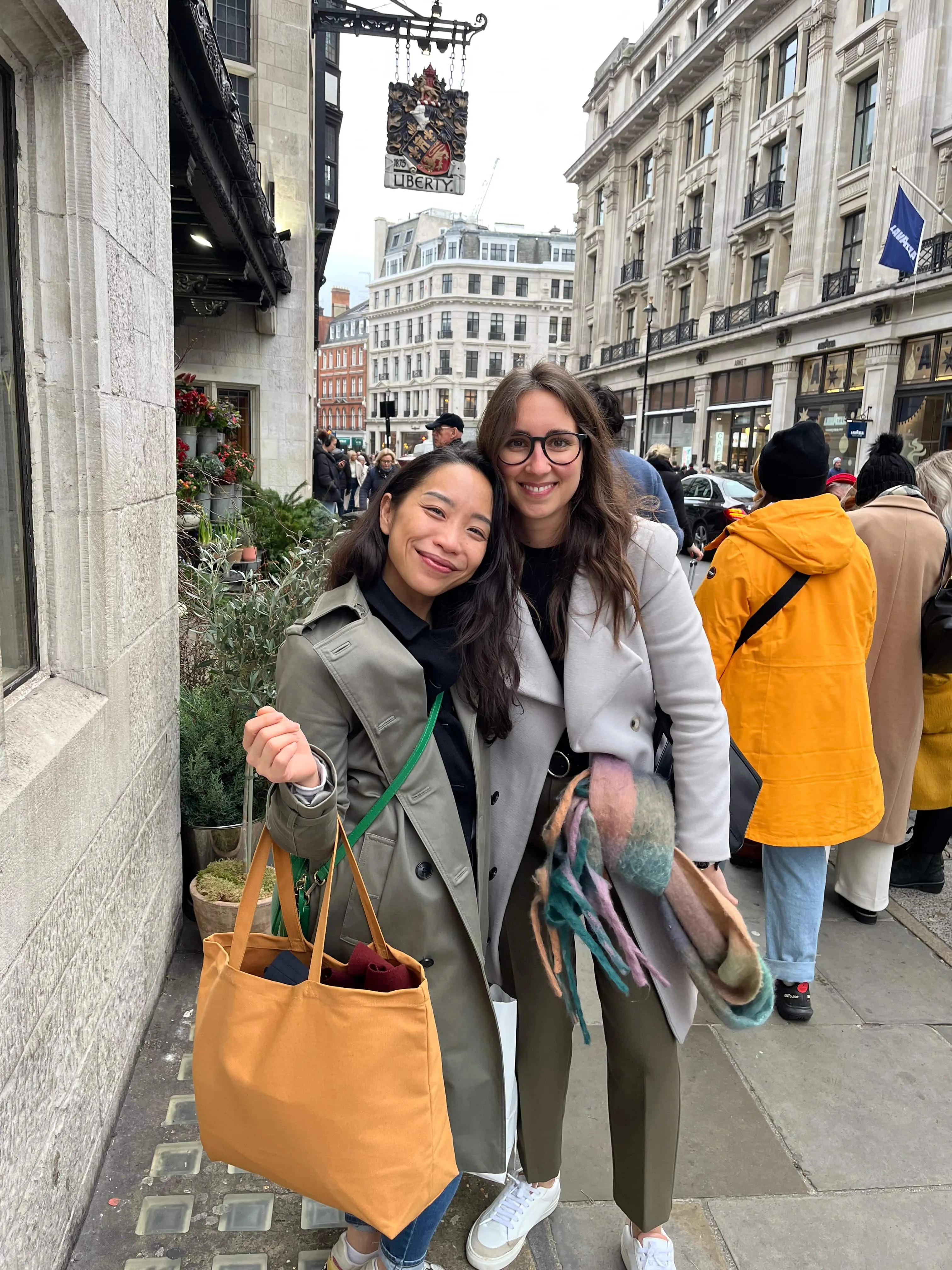Maria Pastor with a smiling client in a trench coat on a London street