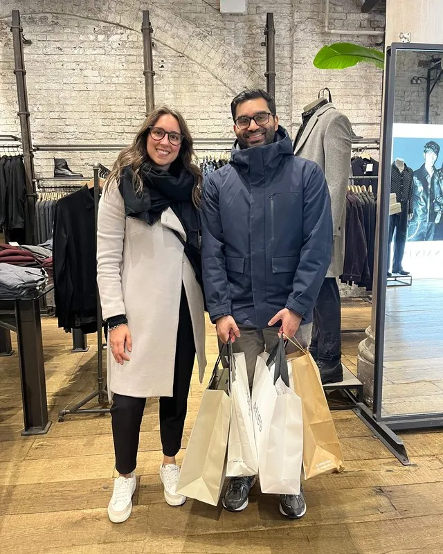 Maria Pastor with a smiling client holding his shopping bags after men's personal shopping